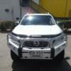 White Nissan SUV With Protector Bar